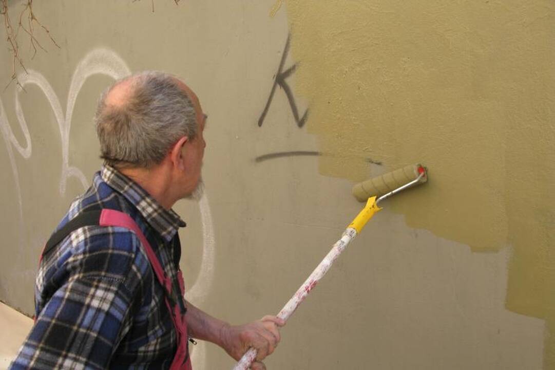 Darbininkai senamiestyje uždažinėjo sienų tepliones